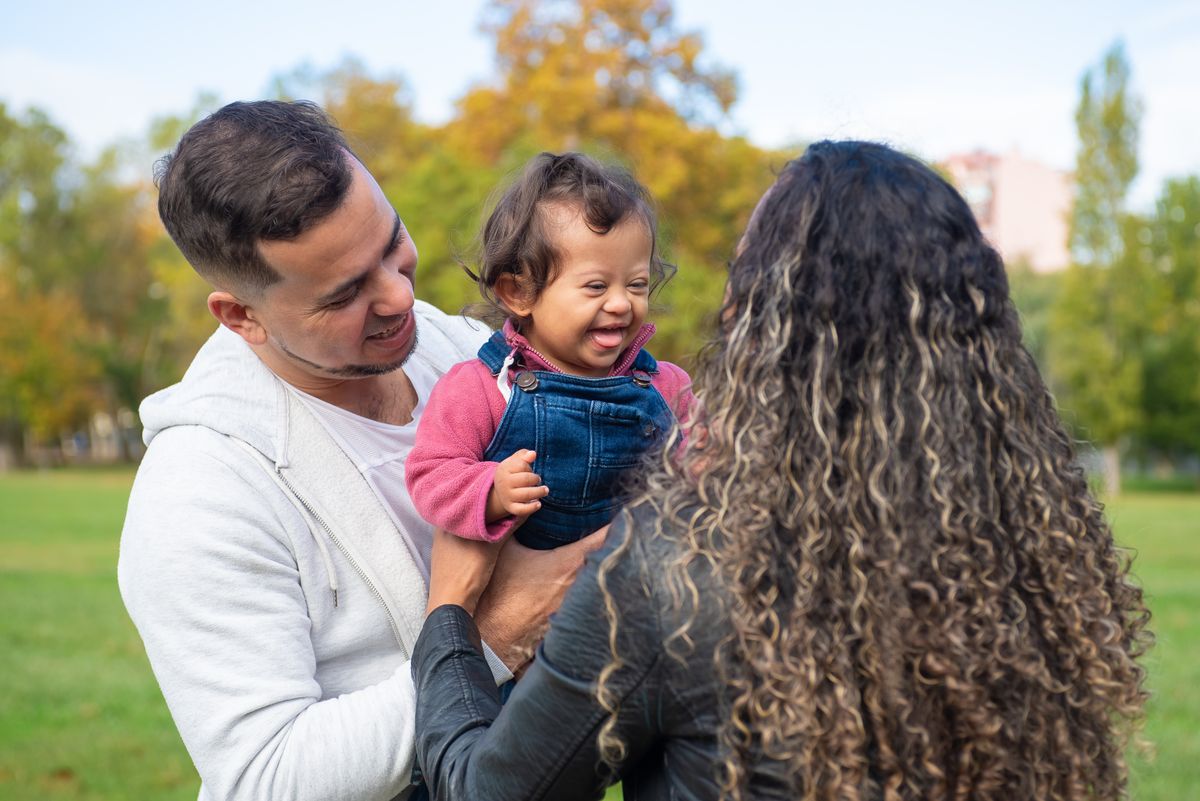 A family enjoying a playful moment together in a park